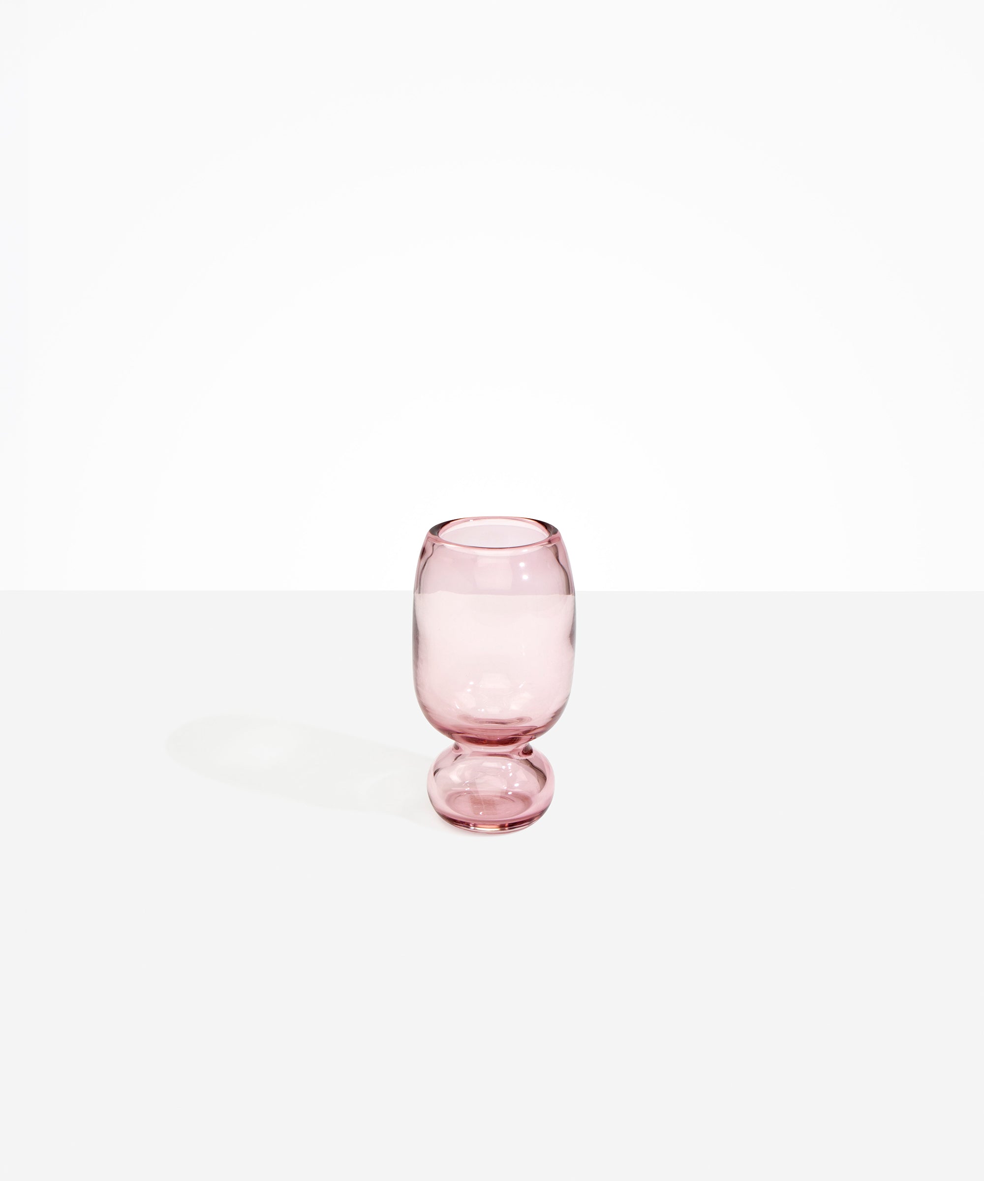 Dinosaur Designs Small Glass Rockpool Vase in Pink — handblown transparent pink glass vase with rounded bulbous body and small spherical pedestal base