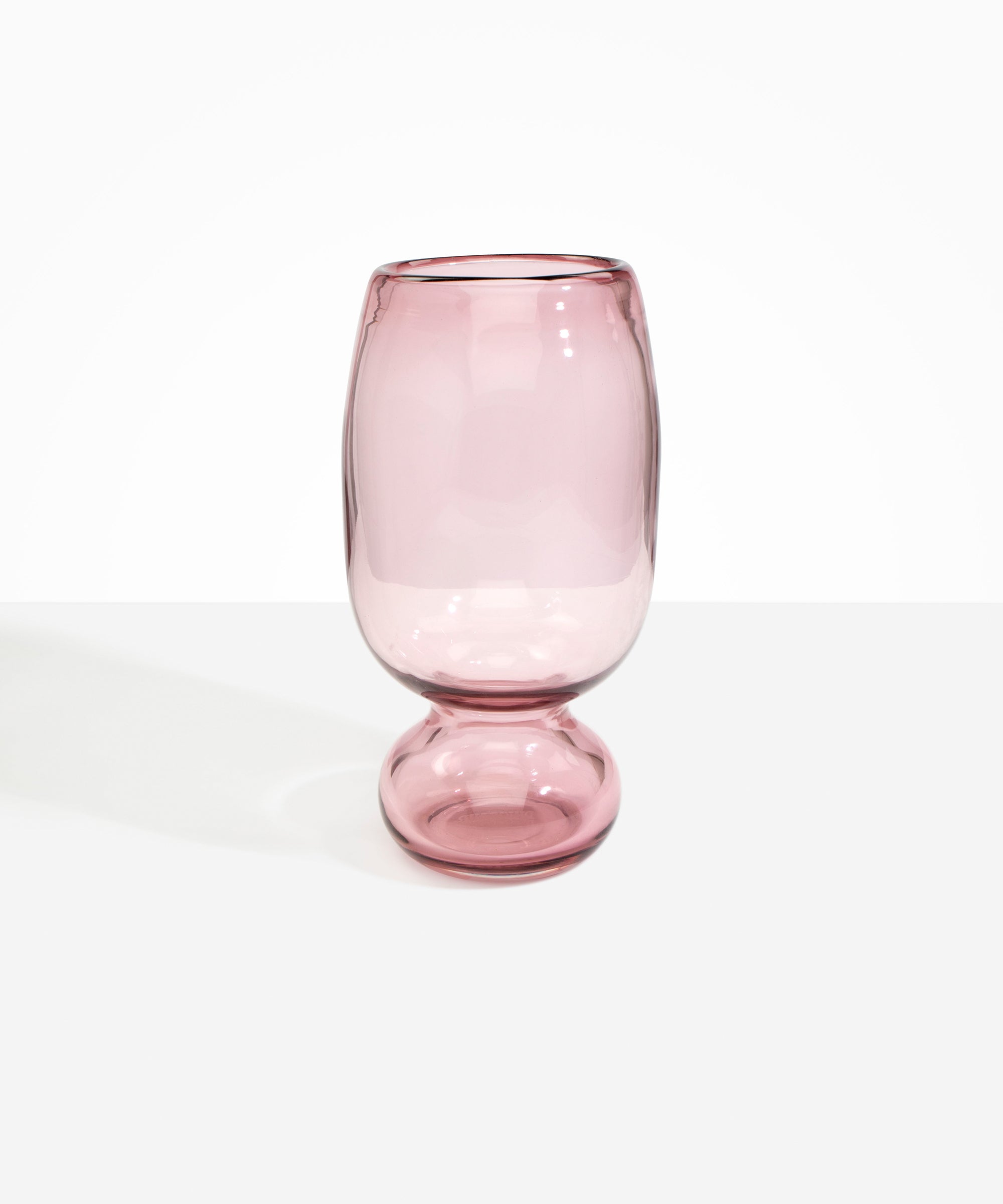Dinosaur Designs Tall Glass Rockpool Vase in Pink — handblown transparent pink glass vase with rounded bulbous body and spherical pedestal base