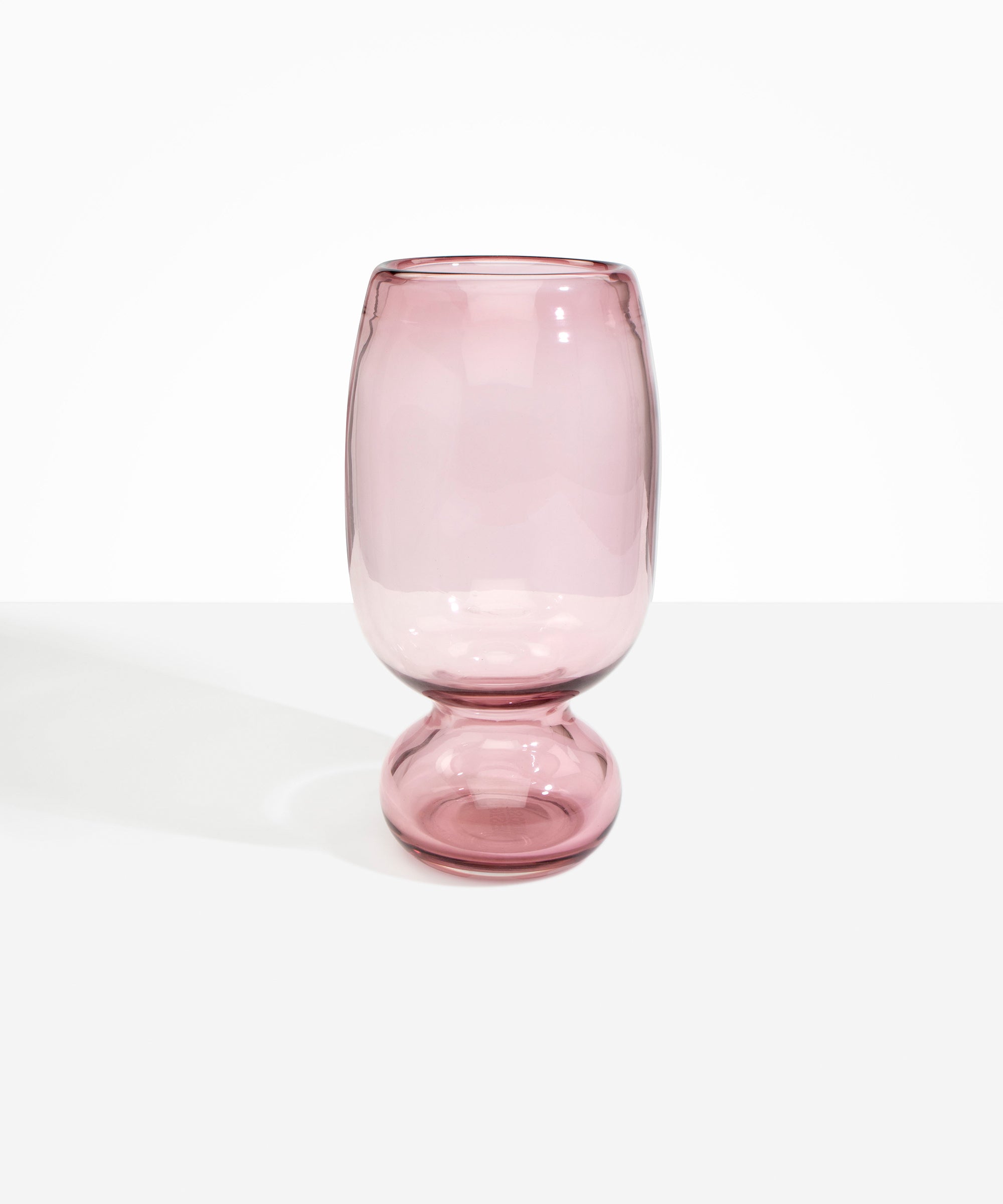 Dinosaur Designs Tall Glass Rockpool Vase in Pink — handblown transparent pink glass vase with rounded bulbous body and spherical pedestal base
