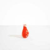 Dinosaur Designs medium sized Liquid vase in daisy red and cream colour resin