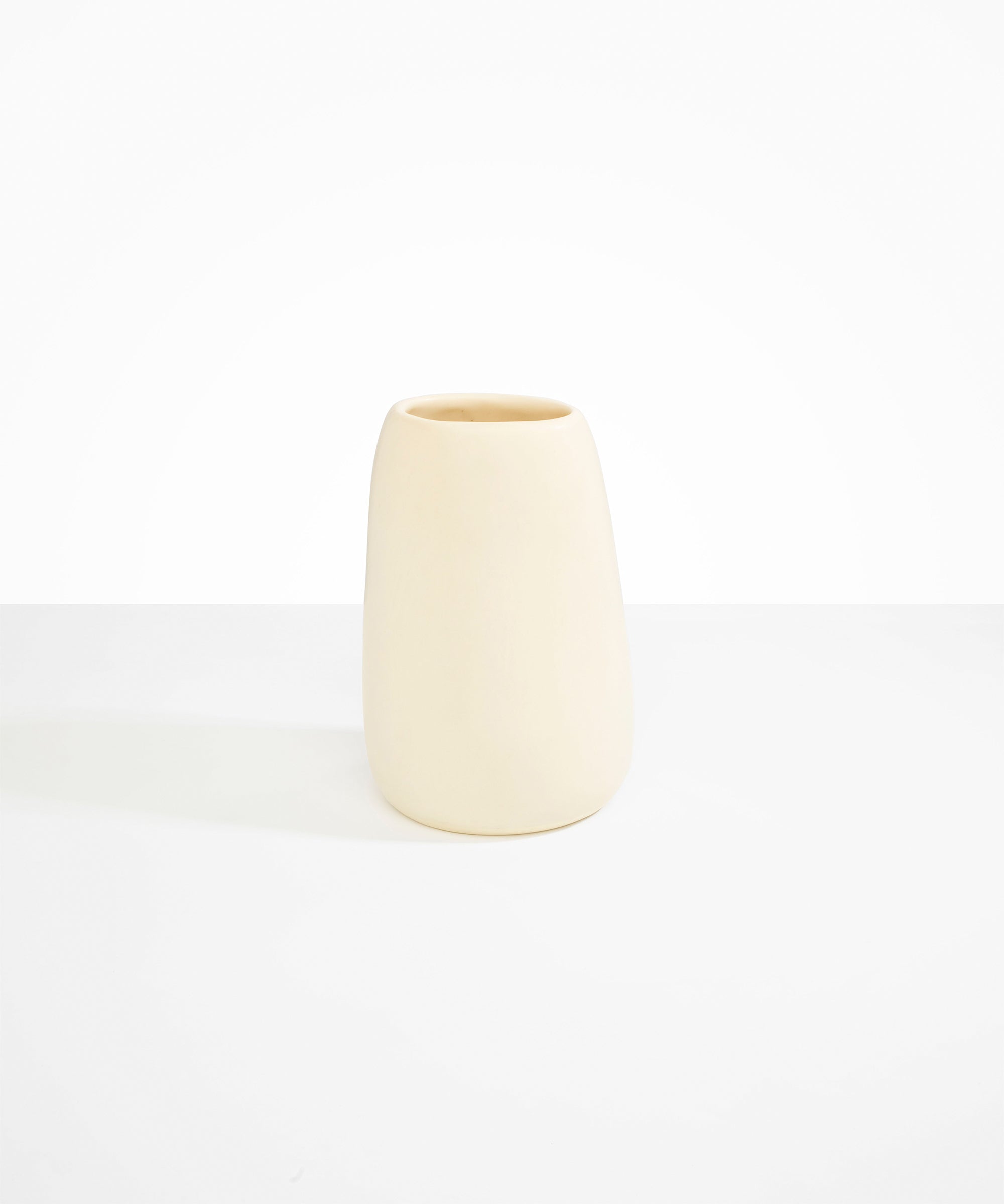 Dinosaur Designs Large Pebble Vase in Cream — handcrafted cream resin vase with smooth rounded pebble form and narrow opening