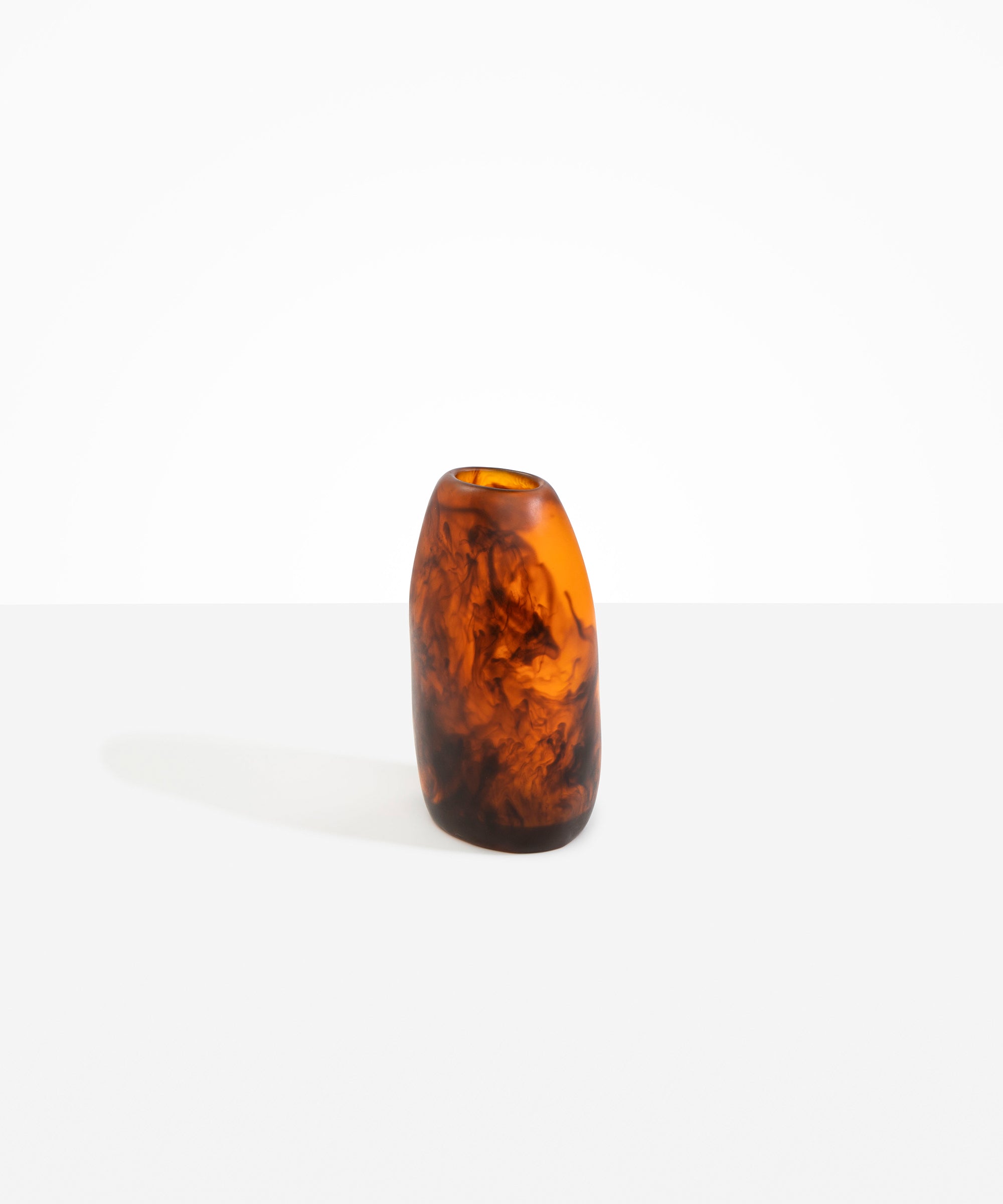 Dinosaur Designs Medium Pebble Vase in Tortoise — handcrafted marbled amber and black resin vase with smooth rounded pebble form and narrow opening