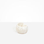 Dinosaur Designs Orchid Vase in Chalk Swirl — handcrafted marbled off-white resin vase with short rounded organic form and sculpted open petal-shaped rim