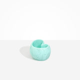 Dinosaur Designs Orchid Vase in Mint — handcrafted marbled mint blue resin vase with short rounded organic form and sculpted open petal-shaped rim