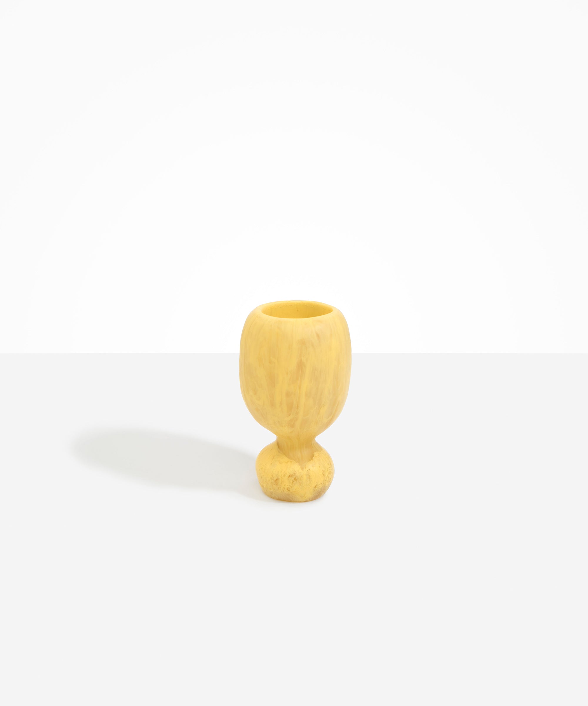 Dinosaur Designs Small Rockpool Vase in Pollen — handcrafted marbled yellow resin vase with rounded bulbous body and small spherical pedestal base