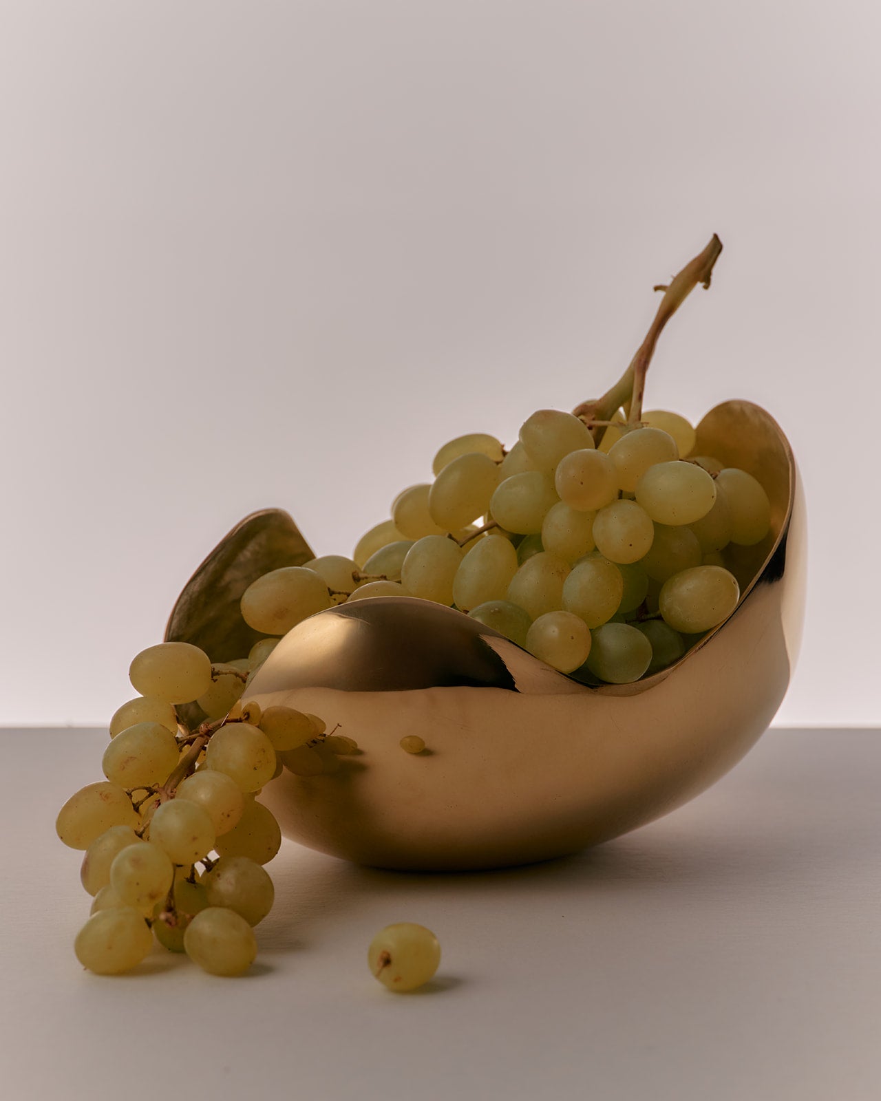 Brass bowl with grapes