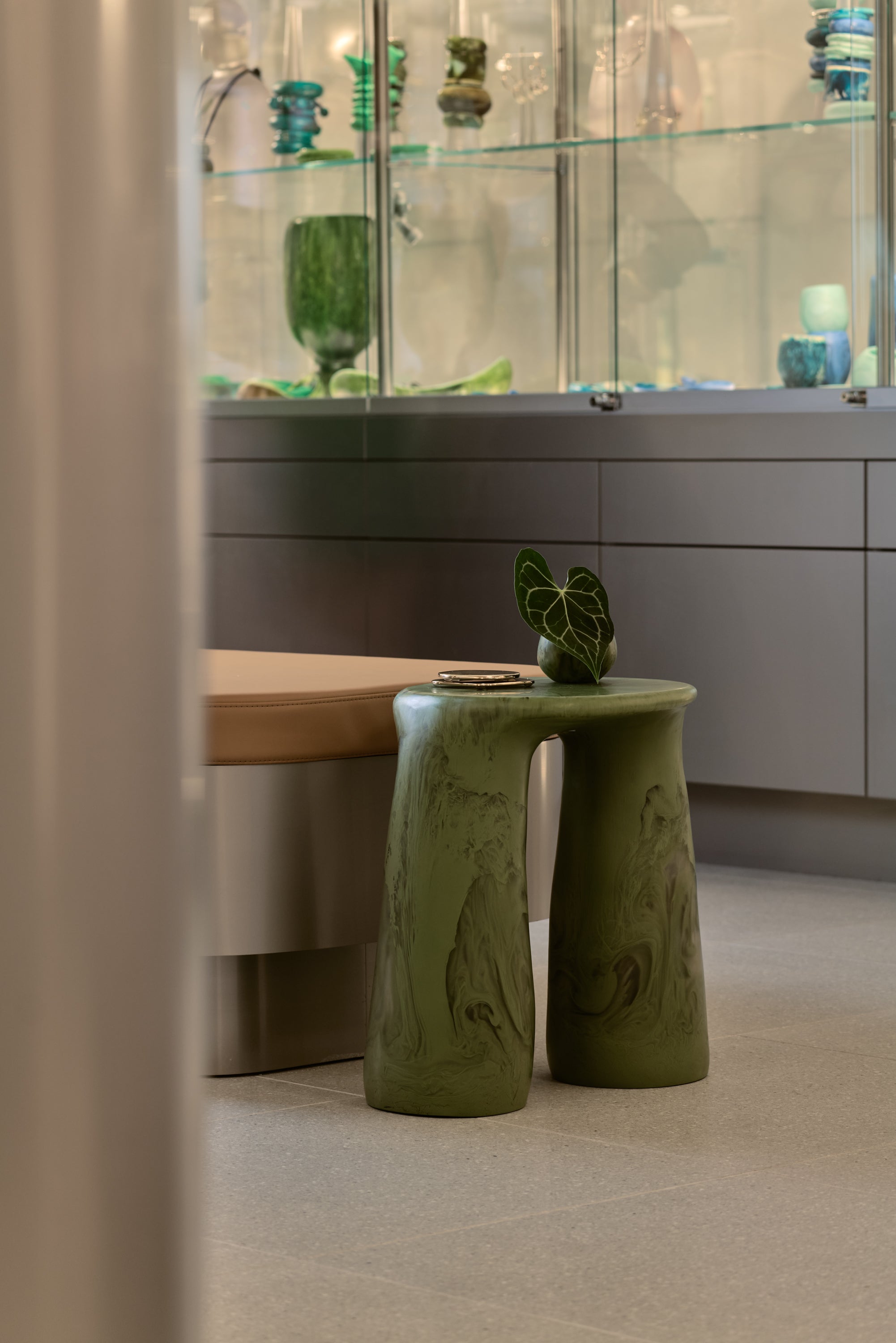 Green two legged handmade table within interior of store